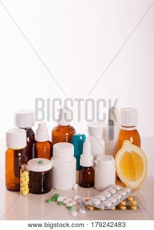 Composition of medicine bottles and pills isolated on white. vertical short