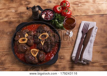 roasted meat on the bone Osso Buco in tomato sauce