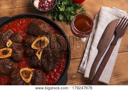 roasted meat on the bone Osso Buco in tomato sauce