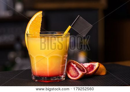 Alcoholic beverage based on table with ice cubes and oranges