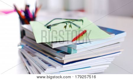 Group of multicolored office folders and glasses.