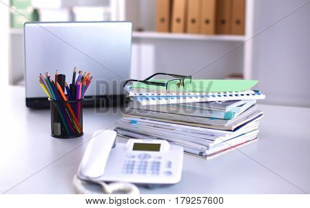 Group of multicolored office folders and glasses.