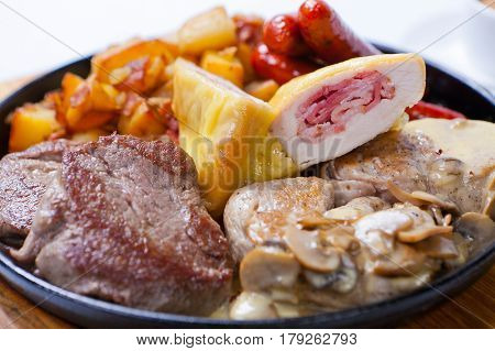 Grilled Sausages With Potatoes, Mushrooms And Roasted Chicken On A Grill Pan