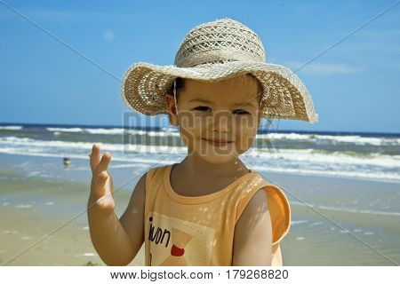 Cute asian  smiling child,  sea and  natural background