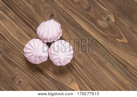 Pink vanilla marshmallows on a wooden background. Top view