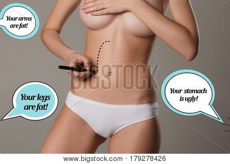 Women belly with the drawing arrows. The cellulite removal plan. White markings on young woman body preparing for plastic surgery. Concept of slimming, liposuction, strand lifting