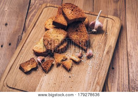 Bread crumbs spices and garlic on the wooden background.