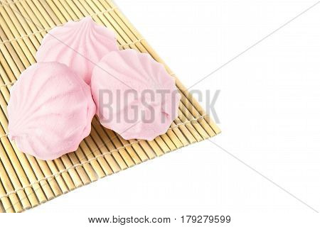 Pink vanilla marshmallows on a white background. Close up