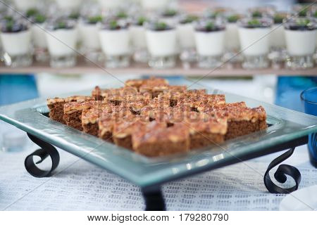 Delicious toffee cakes on plate for party