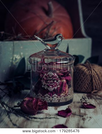 Rose buds tea, tea strainer and glass jar. Selective focus.