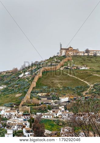 View of Ermita de San Miguel Alto with wall from Generalife gardens Granada Spain