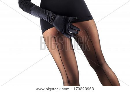 Sexy female legs in beautiful stylish stockings and high heels shoes black gloves and dress isolated on white background horizontal view with copy space