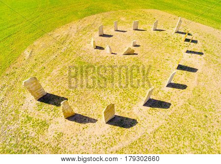 Aerial view of ancient esoteric geomancy symbol in green wheat field. Mystery of Czech countryside. Spring landscape near Pilsen. Czech Republic, Central Europe.