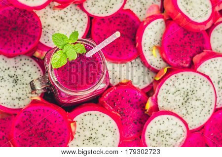 Smoothies Of Red Organic Dragon Fruit And Pieces Of Dragon Fruit On An Old Wooden Background
