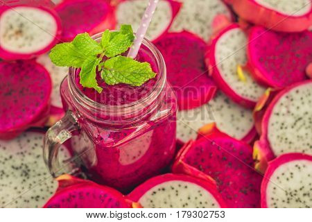Smoothies Of Red Organic Dragon Fruit And Pieces Of Dragon Fruit On An Old Wooden Background