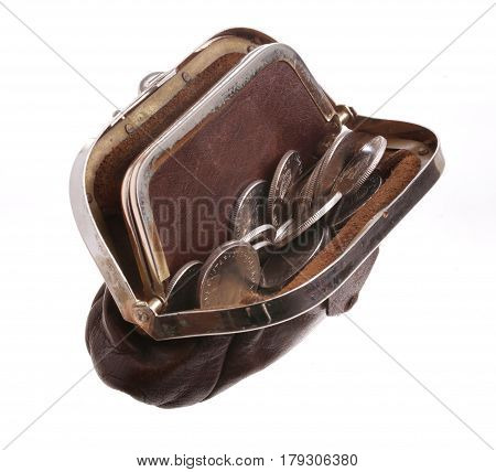 One borwn opened purse filled with coins isolated on white.