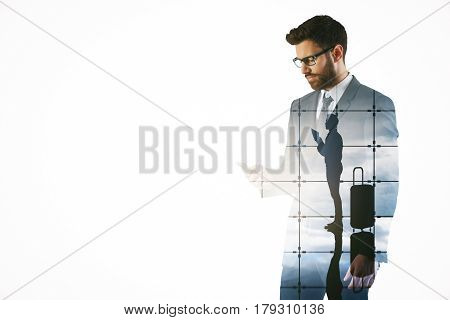 Attractive young bearded man using mobile phone on abstract airport background. Traveling concept. Double exposure