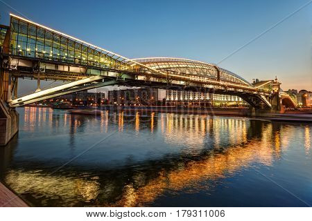 MOSCOW - AUGUST 20, 2013: Bogdan Khmelnitsky bridge at night. It is a beautiful pedestrian bridge across the Moscow River near Kievsky railway station.