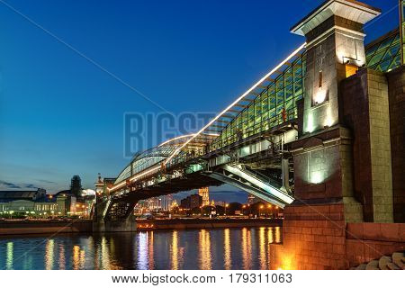 MOSCOW - AUGUST 20, 2013: Bogdan Khmelnitsky bridge at night. It is a beautiful pedestrian bridge across the Moscow River near Kievsky railway station.
