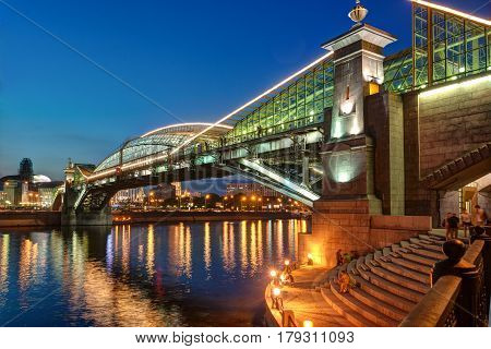 MOSCOW - AUGUST 20, 2013: Bogdan Khmelnitsky bridge at night. It is a beautiful pedestrian bridge across the Moscow River near Kievsky railway station.