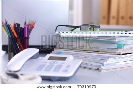 Group of multicolored office folders and glasses.