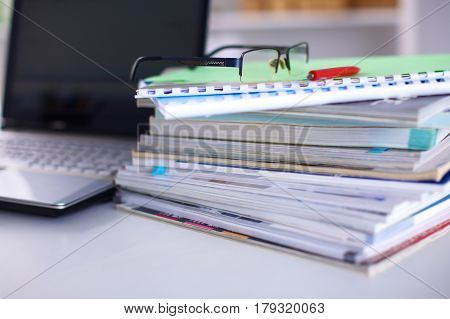Group of multicolored office folders and glasses.