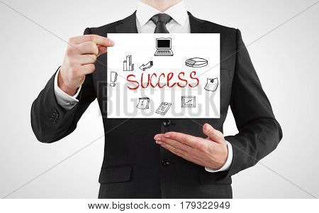 Businessman in suit holding poster with business sketch. Success concept