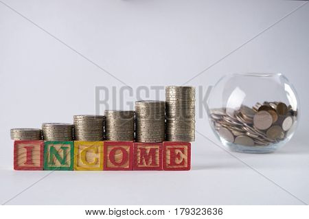 Close-up photo with golden coins in Piggy bank.Income increase concept with upward pile of coins isolated on white background.