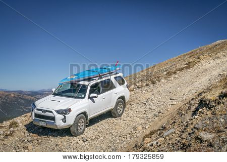 LEADVILLE, CO, USA - SEPTEMBER 27, 2016: Toyota 4Runner SUV (2016 Trail edition) with a paddleboard descending  from the Mosquito Pass on a rocky jeep trail in Colorado's Rocky Mountains