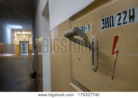 The old big electric knife switch on the wall in the corridor.
