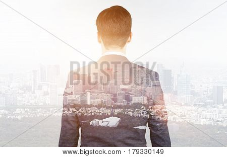 Rear View Of Businessman Looking At City