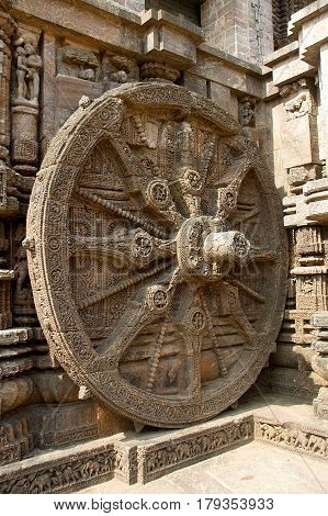 Detail of intricately carved stone wheel of chariot at Sun Temple in Konark Orissa India Asia