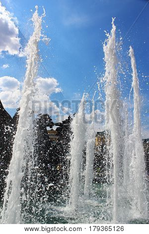 The water jets of the fountain "Geyser" in Moscow on background of blue sky