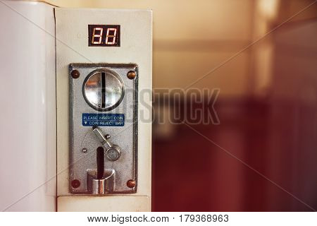 Old coin reject bar. Coin-operated washing machine. integrated payment system.