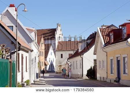 Visby Sweden - May 12 2016: People in motion at the street Strandgatan in the Visby old town located in the Swedish province of Gotland.