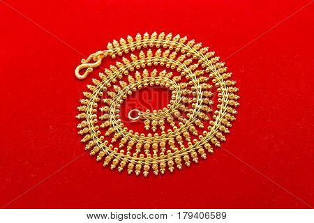 Ornament Golden Necklace Isolated on Red Background