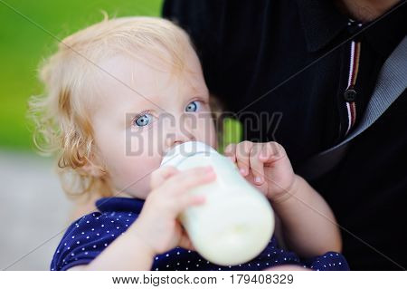 Toddler Girl Drinking Milk From Bottle