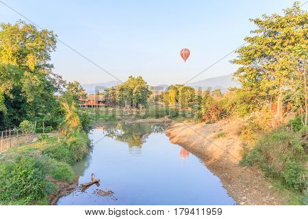 Colorful hot air balloon over mountain and Song river VangVieng Laos