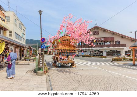 NIKKO JAPAN - APRIL 16 2014: A wooden hana-yadai is being walk around in downtown of Nikko to celebrate and welcome spring season with fancy Japanese costume Nikko Japan