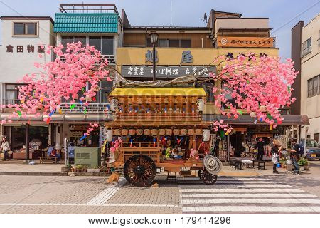 NIKKO JAPAN - APRIL 16 2014: A wooden hana-yadai is being walk around in downtown of Nikko to celebrate and welcome spring season with fancy Japanese costume Nikko Japan