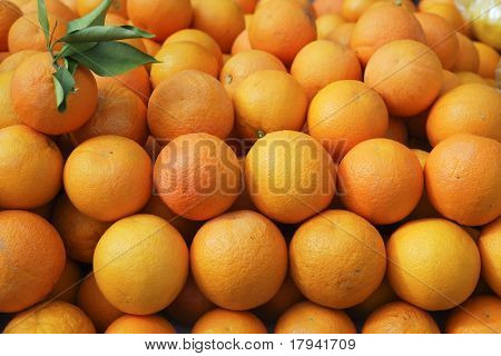 Valencia oranges stacked on market in mediterranean spain