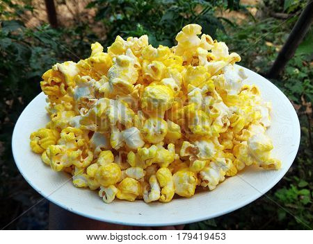 deail of many popcorn on white dish
