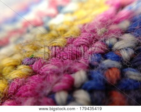 Colored yarn knitted art. Background in macro