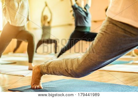 Group of old and young women doing yoga in Vipassana meditation school centre - Spiritual concept for healthy and relax lifestyle - Focus on female bottom foot - Warm contrast filter