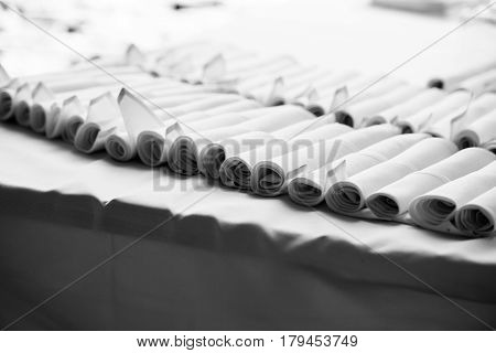 Folded table napkins on the table. Black and white photo