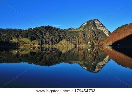Mount Gross Aubrig mirroring in lake Wagital. Autumn scene in the Swiss Alps.