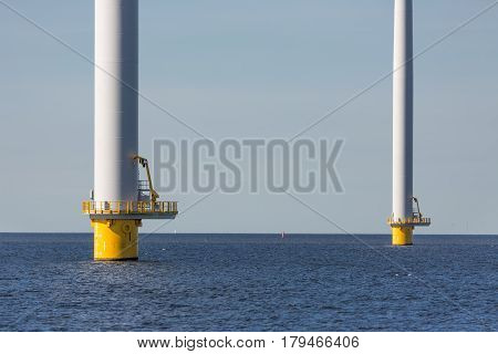 Foundation of big wind turbines standing in the sea