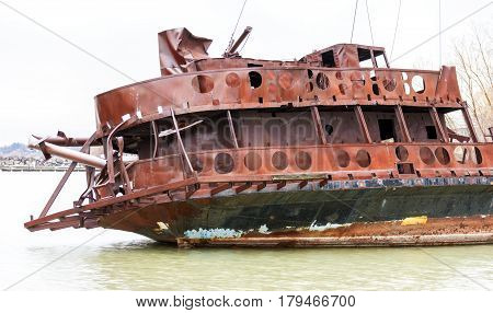 Bent and broken shipwreck marooned near shore closeup detail