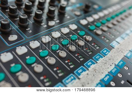 Music equipment closeup. Management console sound design at the event. Big black mixer with control knobs.