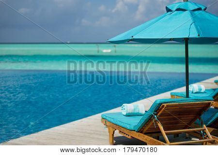 A soft blue chaise lounge in Maldivian resort